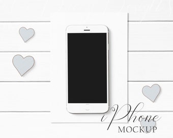 iPhone Mockup Styled with paper and rustic heart accents on a white wood background.