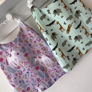 customizable waterproof organic terry cloth elasticated canteen towel, nursery towel, large elastic bib