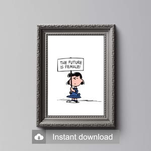Può includere: Un'illustrazione in bianco e nero di una ragazza che tiene un cartello con la scritta "The future is female!" La ragazza indossa un vestito blu e ha i capelli neri. L'illustrazione è incorniciata in una cornice grigia.
