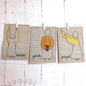 ITH 3 Engel auf Karten gestickt für den Stickrahmen 13x18cm mit den Schriftzügen in Deutsch  "behütet", "gesegnet" und "geliebt".