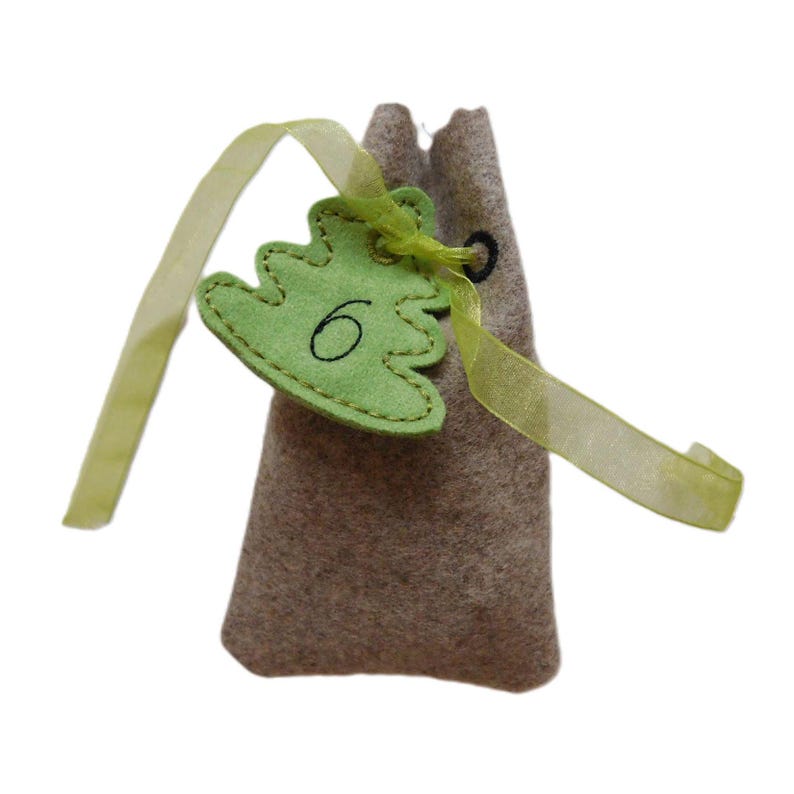 Advent Calendar Bags and Numbers From 124 on a Small Christmas Tree
