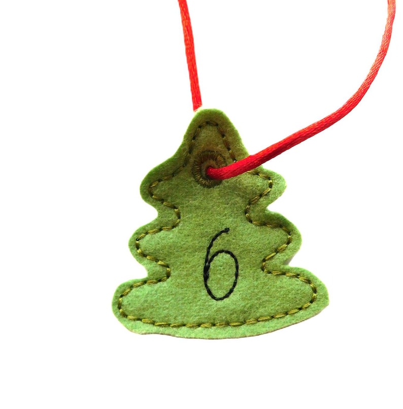 Advent Calendar Bags and Numbers From 124 on a Small Christmas Tree