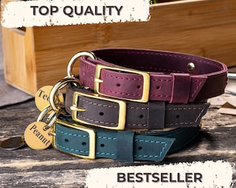 Puede incluir: Tres collares de cuero para perros en burdeos, marrón y verde azulado, apilados sobre una superficie de madera. Cada collar tiene una hebilla dorada y una etiqueta a juego. La parte superior de la imagen dice "TOP QUALITY" y la inferior dice "BESTSELLER".