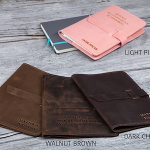 May include: Four leather-bound journals in different colors: olive, walnut brown, dark chocolate, and light pink. Each journal has a personalized inscription and a strap closure.