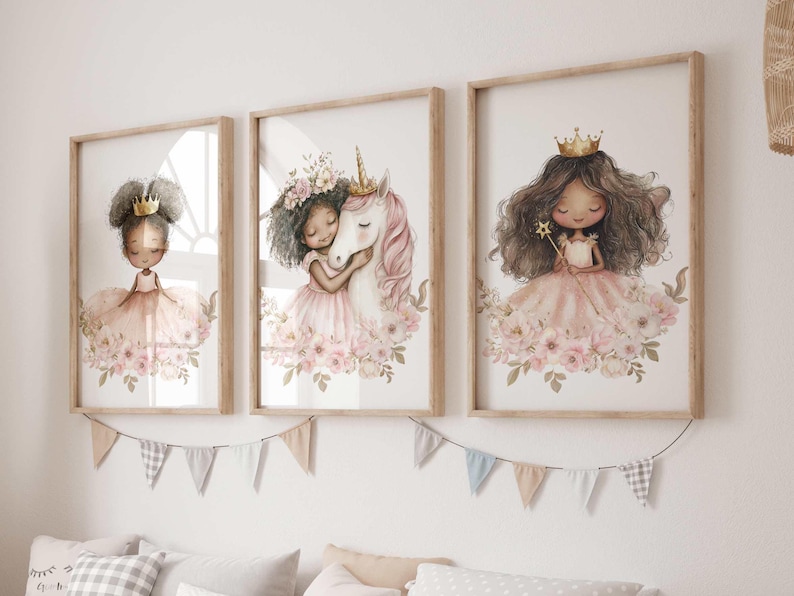 May include: Three framed watercolor prints featuring illustrations of princesses and a unicorn. Each princess wears a crown and a pink dress, surrounded by flowers. The unicorn is white with a pink mane. The frames are light brown.