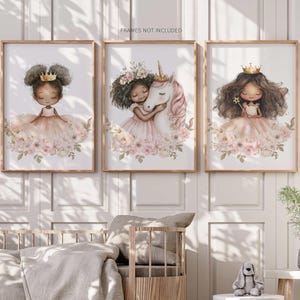 May include: Three framed art prints featuring illustrations of girls in princess dresses. The prints have a soft color palette of pink, peach, and gold. One print shows a girl with a crown, another with a unicorn, and the third with a wand.