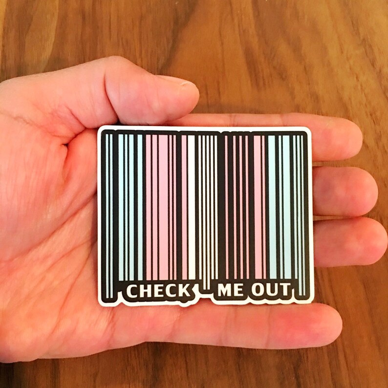 May include: A sticker with a barcode design in black, pink, and blue colors. The barcode has the text "CHECK ME OUT" printed below it.