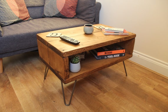 Hairpin leg coffee table with storage outlet