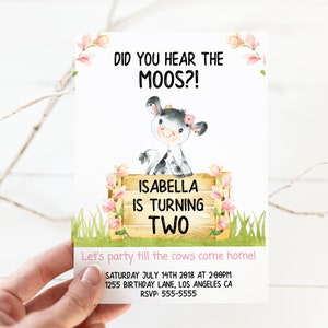 May include: A pink and white cow with a pink flower on her head is standing behind a wooden sign that says "Isabella is turning two". The sign is surrounded by pink flowers. The text "Did you hear the Moos?!" is at the top of the invitation. The invitation also includes the date, time, and location of the party.