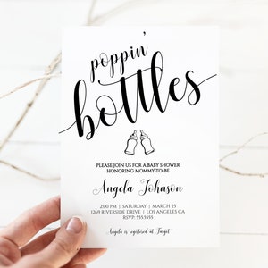May include: A white baby shower invitation with black text that reads "poppin' bottles" with a graphic of two baby bottles. The invitation includes the name "Angela Johnson" and details for the event, including the date, time, and location. The text also states that Angela is registered at Target.
