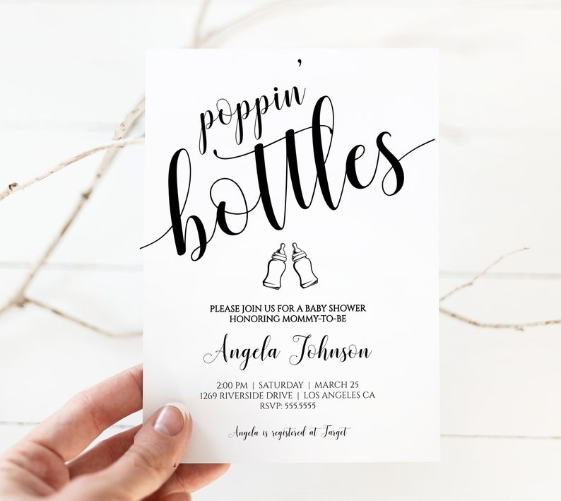 May include: A white baby shower invitation with black text that reads "poppin' bottles" with a graphic of two baby bottles. The invitation includes the name "Angela Johnson" and details for the event, including the date, time, and location. The text also states that Angela is registered at Target.