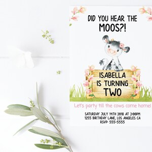 May include: A watercolor illustration of a cow with pink flowers on its head. The cow is standing on a wooden fence with pink flowers. The text "Did you hear the moos?" is at the top of the card. The text "Isabella is turning two" is on the fence. The text "Let's party till the cows come home!" is at the bottom of the card. The text "Saturday July 14th 2018 at 2:00pm" is below the text "Let's party till the cows come home!" The text "1255 Birthday Lane, Los Angeles CA" is below the date. The text "RSVP: 555-5555" is at the bottom of the card.