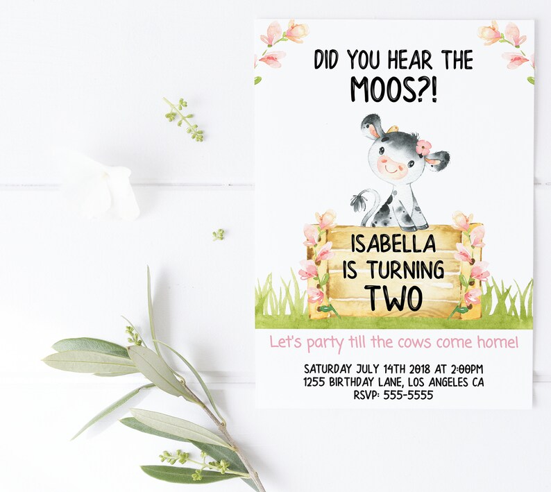 May include: A watercolor illustration of a cow with pink flowers on its head. The cow is standing on a wooden fence with pink flowers. The text "Did you hear the moos?" is at the top of the card. The text "Isabella is turning two" is on the fence. The text "Let's party till the cows come home!" is at the bottom of the card. The text "Saturday July 14th 2018 at 2:00pm" is below the text "Let's party till the cows come home!" The text "1255 Birthday Lane, Los Angeles CA" is below the date. The text "RSVP: 555-5555" is at the bottom of the card.
