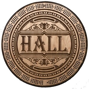 May include: A wooden game board with a circular design. The board has a central area with the word "HALL" in a decorative font. The outer edge of the board has a series of numbers and dots.