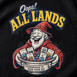 May include: A black t-shirt featuring a graphic of a laughing wizard in a red robe holding a bowl filled with colorful spheres and playing cards labeled Mountain, Forest, Plains, Swamp, and Island. The text reads Oops! ALL LANDS and GUARANTEED TO RUIN YOUR DAY.
