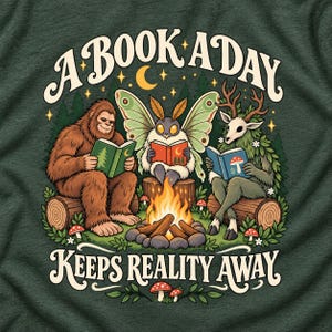 May include: A dark green t-shirt featuring a graphic of a brown Bigfoot, a moth with large wings, and a deer-like creature with antlers, all reading books around a campfire. The text reads A BOOK A DAY KEEPS REALITY AWAY in cream lettering.
