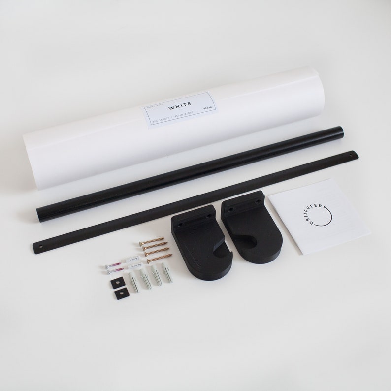 May include: A black metal poster hanger kit with two black brackets, screws, and a white rolled poster with the text "WHITE THE SANDY / SNOW WHITE" on it.