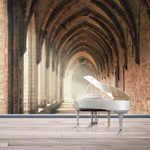 May include: A white grand piano with the lid open sits in front of a brick archway. The archway is long and narrow, with a light at the end of the hallway.