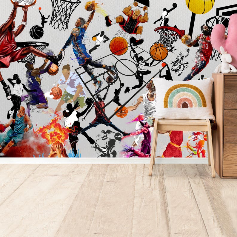 A gym interior with a wall mural featuring a basketball theme. The mural is a collage of basketball players in various poses, basketballs, and basketball hoops. The gym also has a weight bench, dumbbells, a kettlebell, and a blue exercise ball.