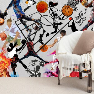 A gym interior with a wall mural featuring a basketball theme. The mural is a collage of basketball players in various poses, basketballs, and basketball hoops. The gym also has a weight bench, dumbbells, a kettlebell, and a blue exercise ball.