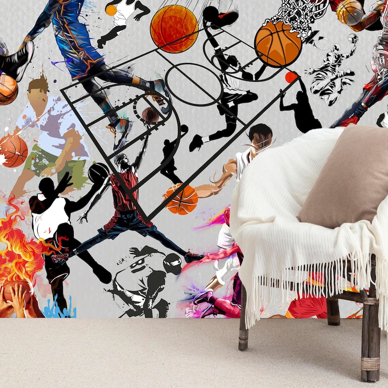 A gym interior with a wall mural featuring a basketball theme. The mural is a collage of basketball players in various poses, basketballs, and basketball hoops. The gym also has a weight bench, dumbbells, a kettlebell, and a blue exercise ball.