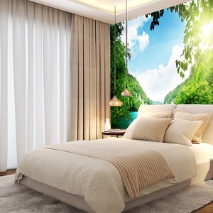 May include: A bedroom featuring a large wall mural depicting a verdant landscape with a river and mountains. The bed is dressed with beige linens and pillows. The room has beige curtains and a white rug.