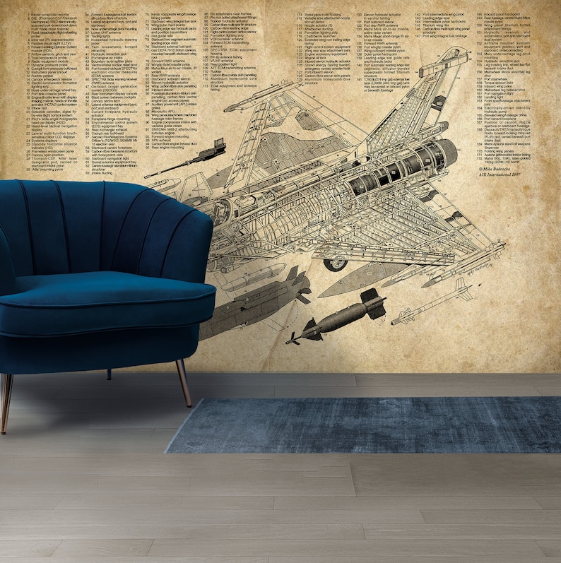 May include: A detailed cutaway illustration of a Dassault Rafale fighter jet, showing the internal workings and components of the aircraft. The illustration is on a vintage-style paper background with a blue armchair in the foreground.