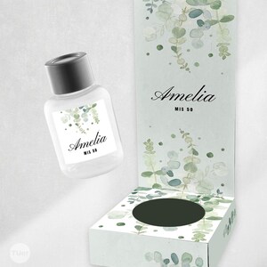 May include: A clear bottle with a black cap and a matching box, both decorated with eucalyptus leaf designs and the name "Amelia". The box has a circular opening. The text "MIS 50" is also visible.