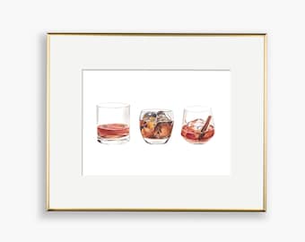 May include: Watercolor print of three cocktail glasses. The first glass contains a reddish-brown liquid. The second glass has ice cubes. The third glass has ice cubes, a cherry, and a cinnamon stick. The print is in a gold frame.