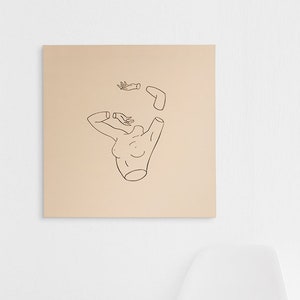 May include: A black and white line drawing of a woman with her arms raised above her head. The drawing is on a light beige background and is framed in a simple black frame.