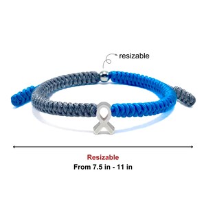 May include: Adjustable bracelet with a gray and blue braided cord design. The bracelet features a silver-colored ribbon charm. The text on the image reads "Resizable From 7.5 in - 11 in."