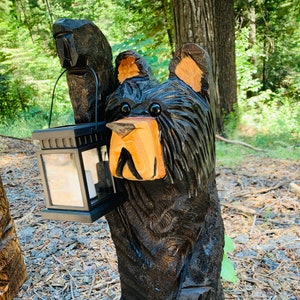 Black bear with solar lantern cedar chainsaw carving