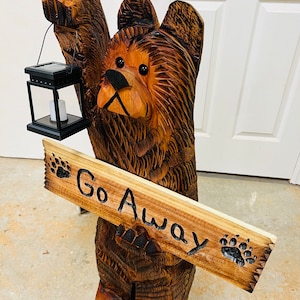 3 foot tall cedar bear chainsaw carving with go away sign