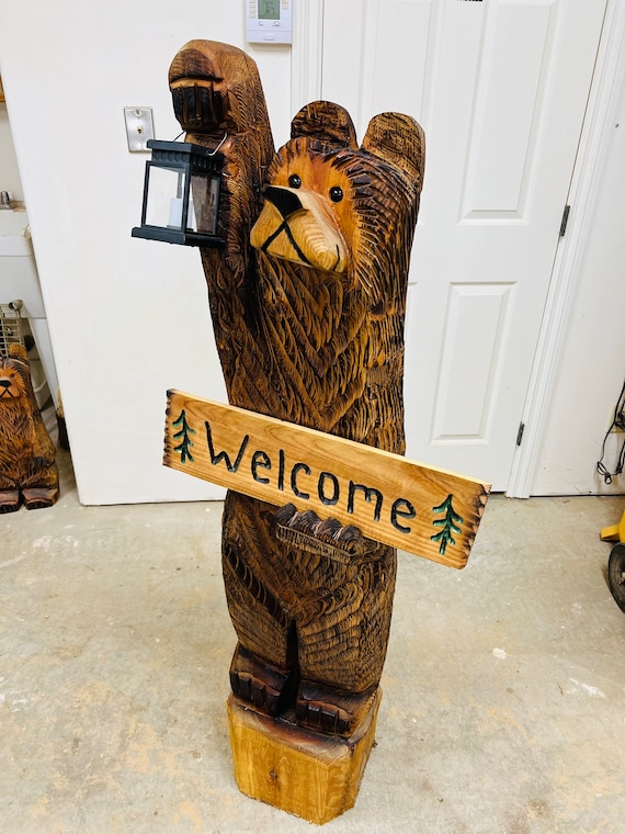 5ft cedar bear chainsaw carving with solar lantern and personalized sign