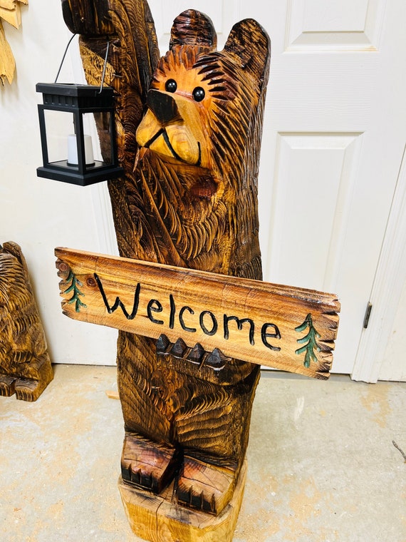 4ft cedar bear chainsaw carving with solar lantern and personalized sign
