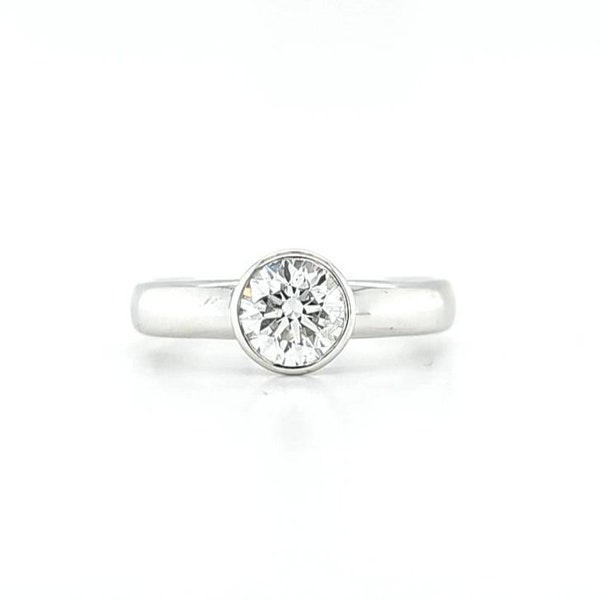 Circa 1995, a 14k white gold bezel set diamond solitaire ring, finger size 6.5.