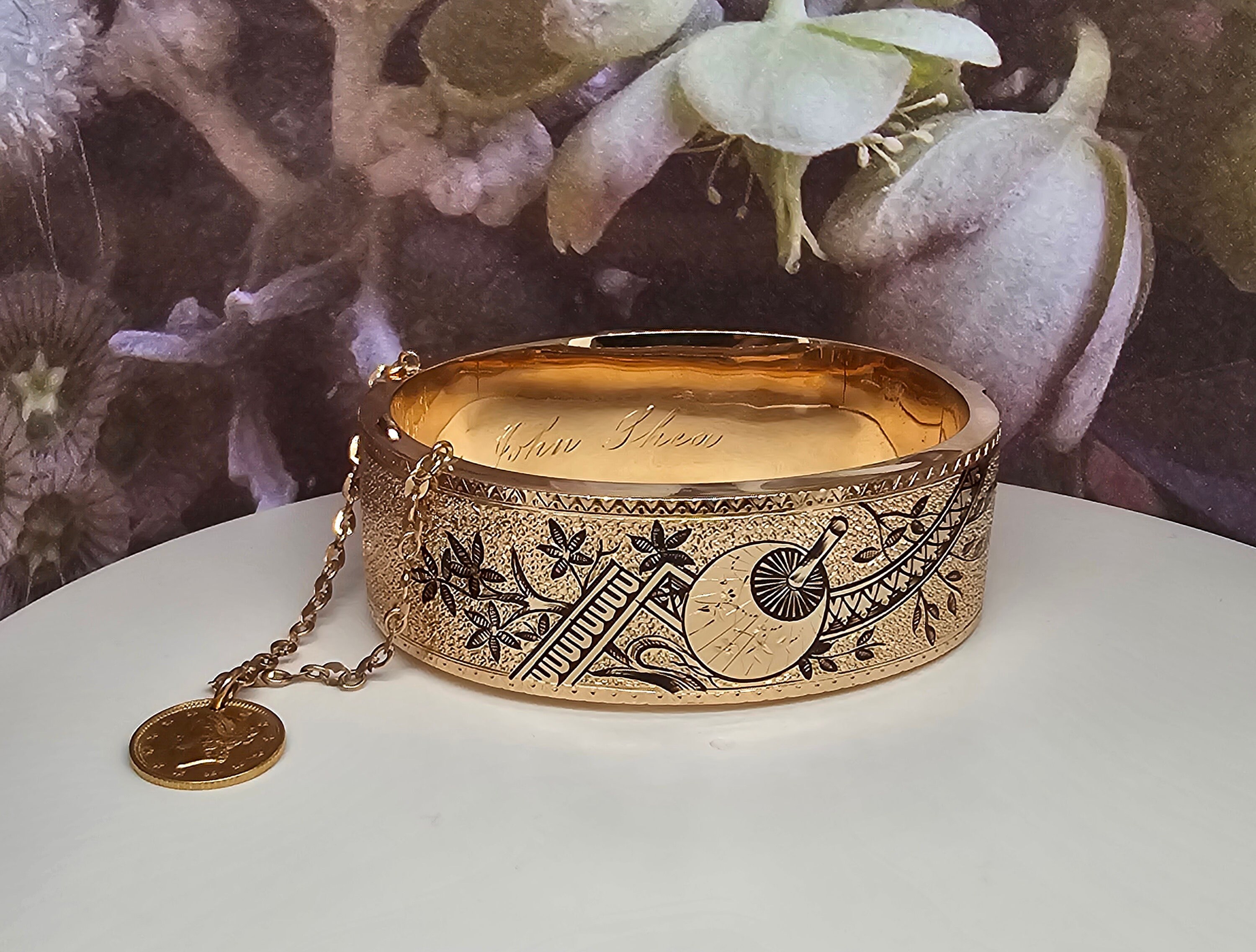 Circa 1900 a 20mm wide 14k yellow gold flat hinged bangle bracelet with Black enameling top and bottom