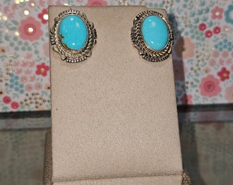 Circa 2000, handmade Navajo Native American sterling silver Kingman turquoise stud earrings.