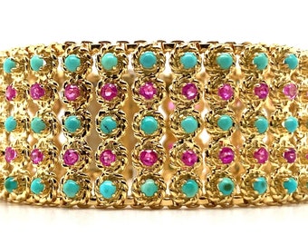 Circa 1960, a 18k yellow gold wide bracelet featuring 3 rows of Turquoise cabochons and 2 rows of pink sapphires. 7" long