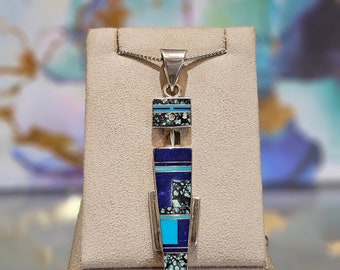 Circa 2000, handmade Zuni sterling silver turquoise, mosaic turquoise, lapis South Western intarsia pendant.