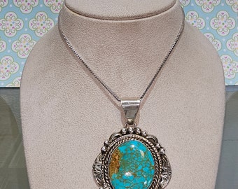 Circa 2000, handmade Navajo Native American sterling silver Royston turquoise pendant.