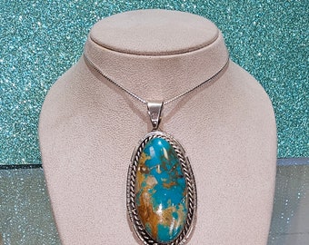 Circa 2000, handmade Navajo Native American sterling silver Turquoise Mountain pendant.