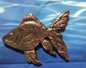 carved goldfish wall decor