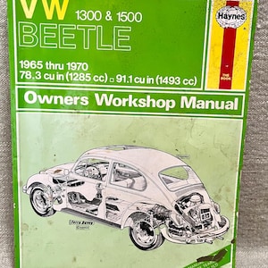 May include: A green and white Haynes Owners Workshop Manual for the VW Beetle 1300 & 1500, covering models from 1965 to 1970. The cover features a detailed illustration of the car's mechanics and includes the text "EVERY MANUAL COMPLETE TEAR AND REBUILD."