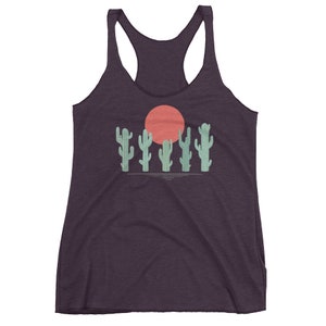 May include: A purple tank top with a graphic of a red sun and five green cacti.