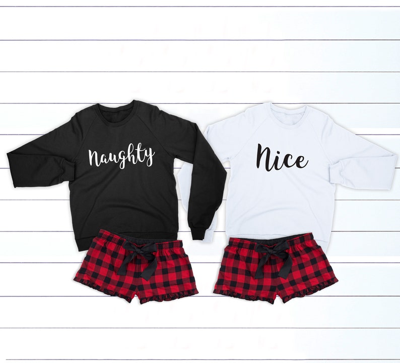 May include: Two matching Christmas pajamas, one black with the word "naughty" in white and one white with the word "nice" in black. Both pajamas have red and black plaid shorts with a black bow.