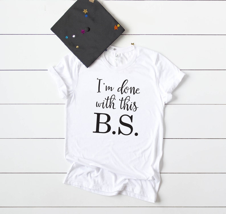 May include: White t-shirt with black text that reads "I'm done with this B.S."
