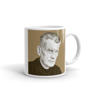 May include: White ceramic mug with a brown background and a black and white illustration of a man with grey hair. The man is looking to the right.