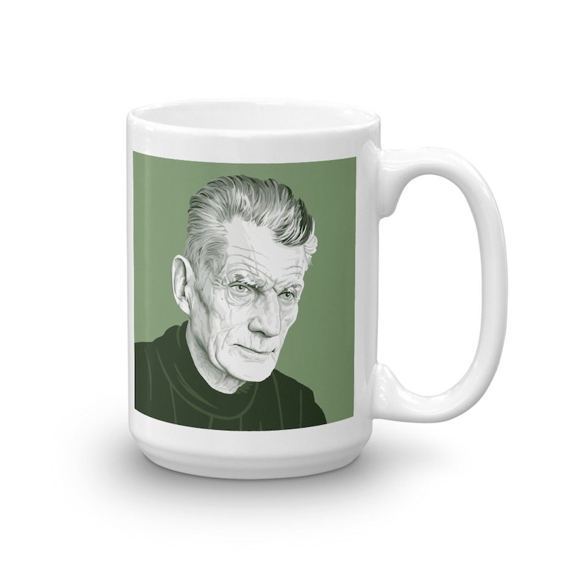 May include: White ceramic mug featuring a green background and a black and white illustration of a man's face. The man has short, grey hair and a serious expression.