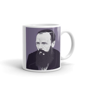 May include: White ceramic mug with a purple background featuring a black and white illustration of Fyodor Dostoevsky, a Russian novelist. The illustration shows Dostoevsky's face and beard.
